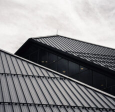 Modern building with sleek, angular rooflines under a cloudy sky.