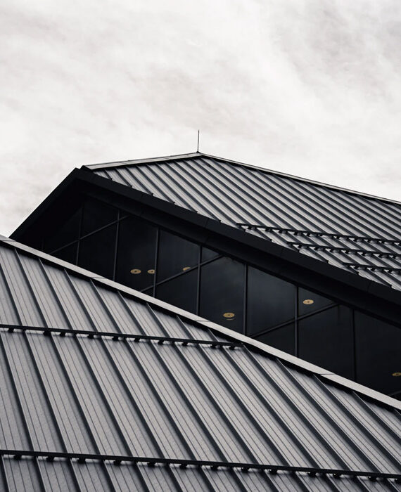 Modern building with sleek, angular rooflines under a cloudy sky.