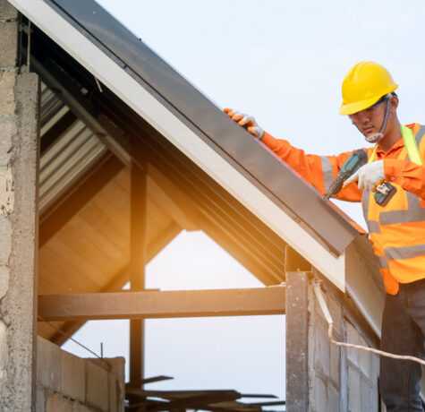 Construction worker installing solar panels on a rooftop.
